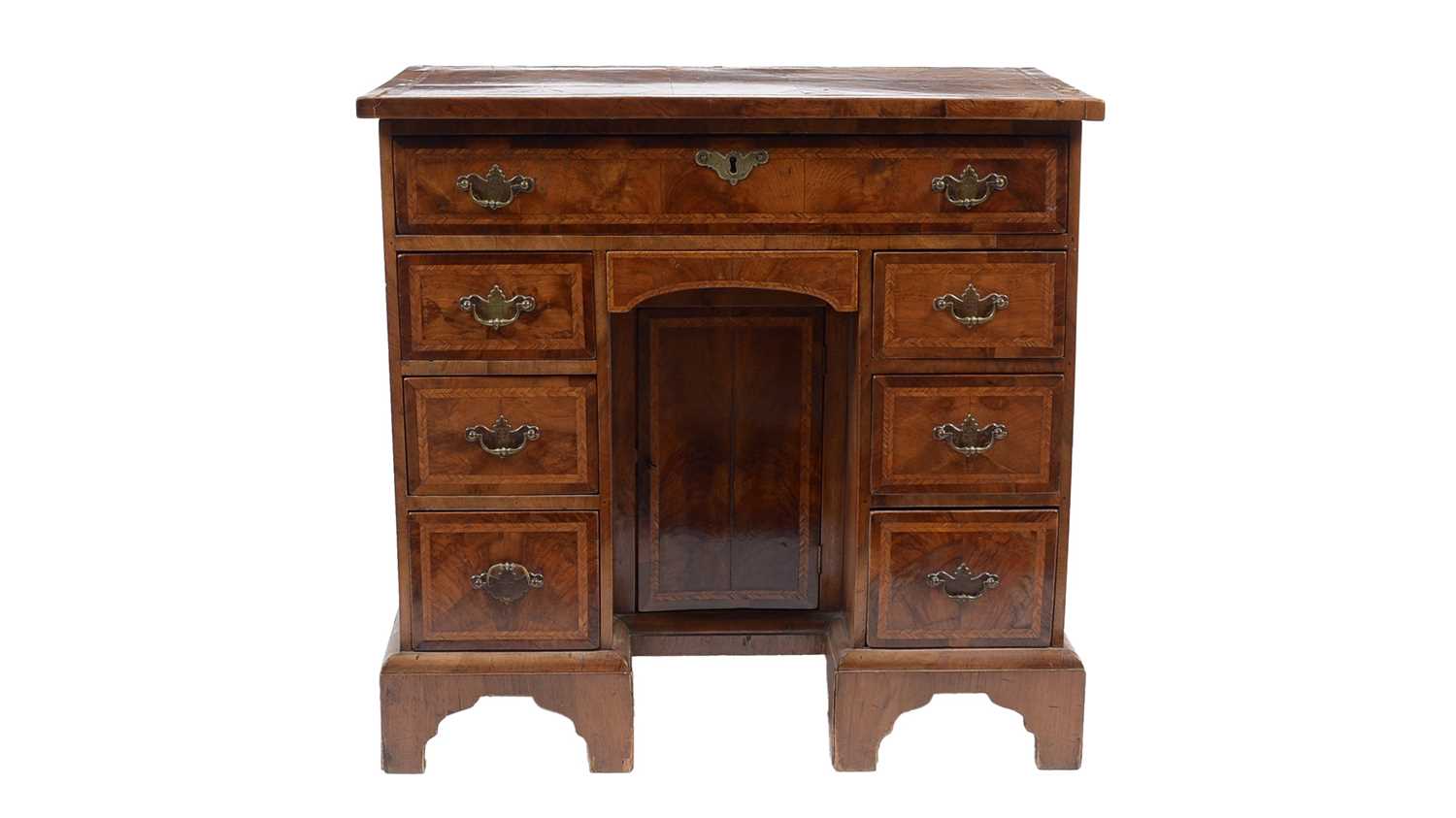 Lot 32 - A George II walnut and feather banded kneehole desk
