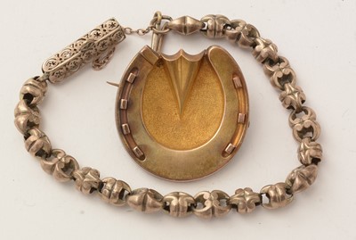 Lot 155 - A gold bracelet, made up from a watch chain, and a brooch