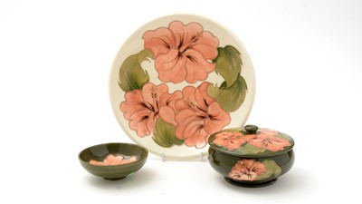 Lot 100 - Moorcroft Hibiscus bowl and cover, plate and small bowl