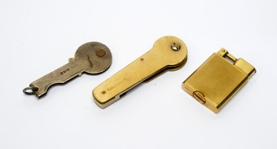 Lot 102 - A 9ct gold lighter; 9ct gold key mount; and a silver key mount