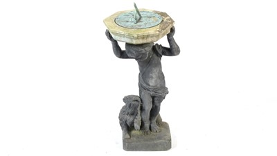 Lot 1326 - A stone and lead sundial raised on a figural base