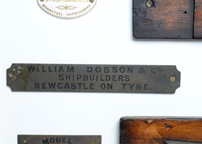 Lot 428 - Stained wood half block model boats, mounted to a board