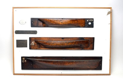 Lot 428 - Stained wood half block model boats, mounted to a board