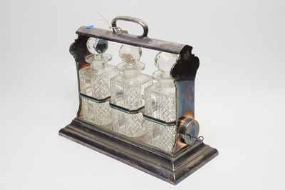 Lot 112 - A silver plated three bottle tantalus