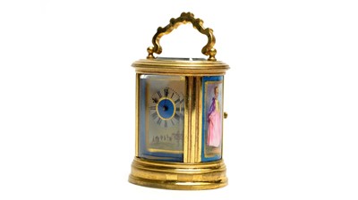 Lot 1259 - A French miniature brass and porcelain oval carriage clock, late 19th Century