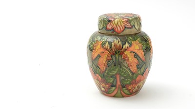 Lot 125 - Moorcroft Tiger Lily pattern ginger jars and cover.