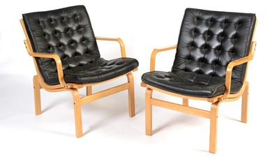 Lot 15 - Nielaus Mobler of Denmark: a pair of mid-Century teak and black leather button back lounge chairs