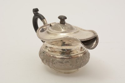 Lot 215 - A 20th Century Indian silver four-piece tea service; a tea strainer; and a drip dish