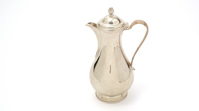 Lot 153 - A George III silver hot water jug