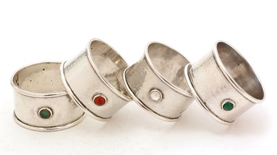 Lot 14 - A set of four George V hand-made silver napkin rings