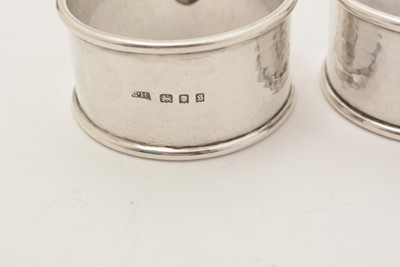 Lot 14 - A set of four George V hand-made silver napkin rings