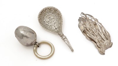 Lot 498 - An Edwardian silver letter clip; a silver spoon; and a child’s silver rattle