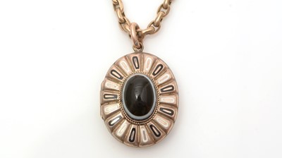Lot 694 - A Victorian mourning locket on muff chain