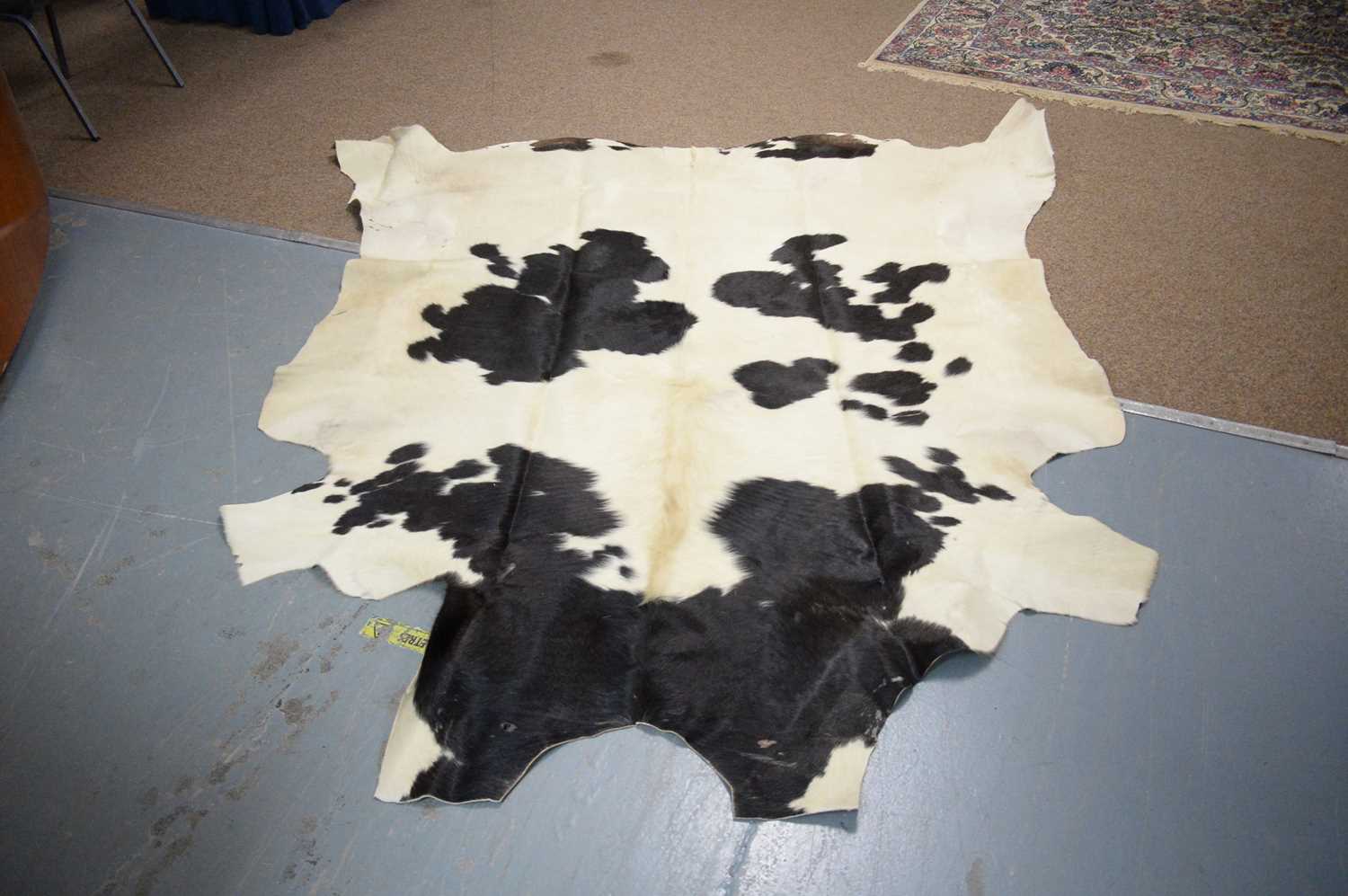 Lot 70 - A cow hide rug