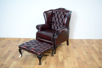 Lot 28 - A reproduction Chesterfield wingback armchair