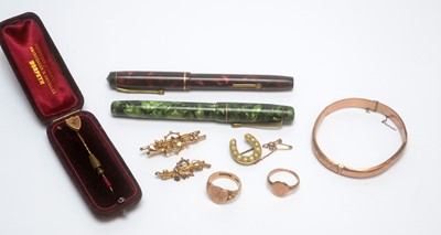 Lot 97 - A 9ct yellow gold bangle, and two fountain pens