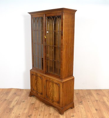 Lot 40 - A Georgian style mahogany and fiddle back mahogany bookcase.