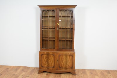 Lot 40 - A Georgian style mahogany and fiddle back mahogany bookcase.