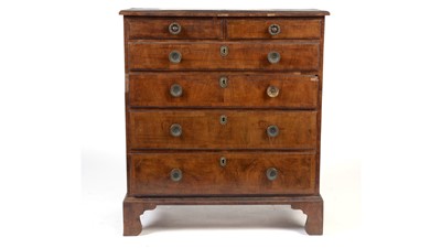 Lot 1401 - A Georgian cross-banded walnut chest of drawers with later amendments