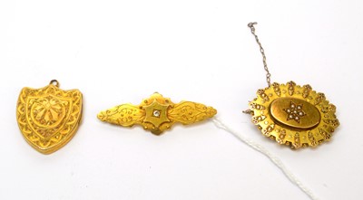 Lot 99 - Two Victorian 15ct yellow gold brooches; and a locket