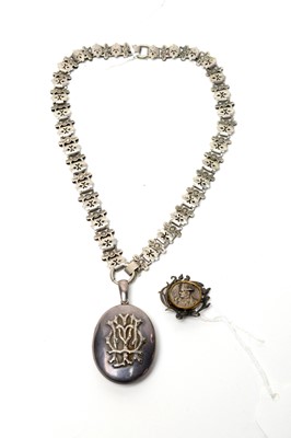 Lot 111 - A Victorian silver locket pendant on chain; and a brooch