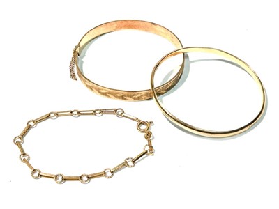 Lot 129 - A 9ct yellow gold bangle, and bracelet and another bangle