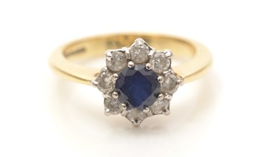 Lot 600 - A sapphire and diamond cluster ring