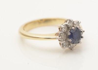 Lot 600 - A sapphire and diamond cluster ring