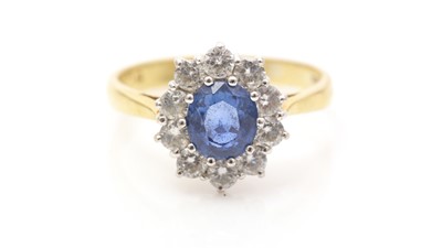 Lot 606 - A sapphire and diamond cluster ring