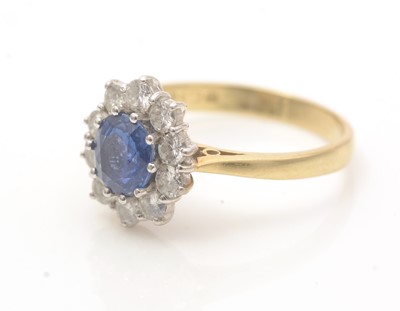 Lot 606 - A sapphire and diamond cluster ring