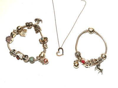 Lot 141 - Two silver Pandora bracelets with a heart shaped pendant on a silver chain