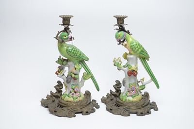 Lot 304 - A pair of ceramic parrot candlesticks