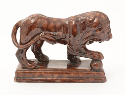 Lot 742 - A 19th Century Staffordshire treacle glazed Medici lion