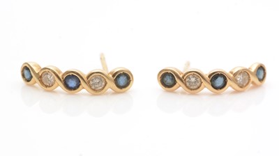 Lot 621 - A pair of sapphire and diamond earrings