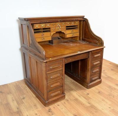 Lot 60 - An early 20th Century roll-top pedestal desk