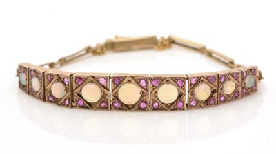 Lot 638 - An opal and ruby bracelet