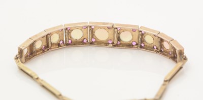 Lot 638 - An opal and ruby bracelet