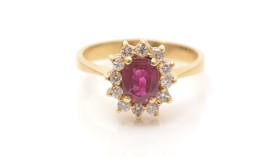 Lot 635 - A ruby and diamond cluster ring
