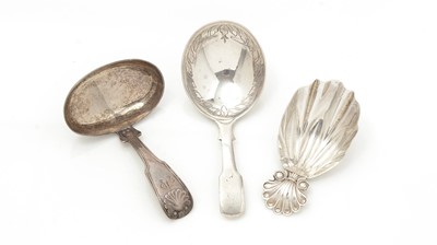 Lot 235 - Three various George III silver caddy spoons