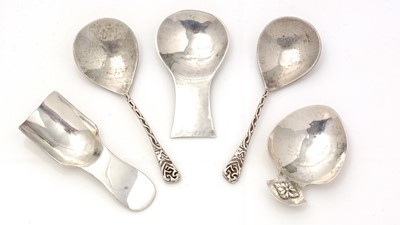 Lot 244 - A pair of George V cast silver caddy spoons; and three others