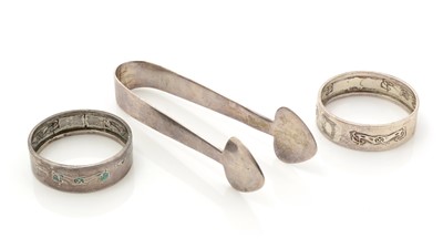 Lot 8 - A pair of Edwardian silver “CYMRIC” sugar tongs; and two napkin rings