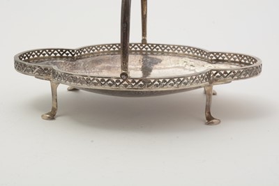Lot 9 - A George V silver swing handled basket; and two silver ashtrays