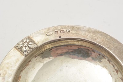 Lot 9 - A George V silver swing handled basket; and two silver ashtrays
