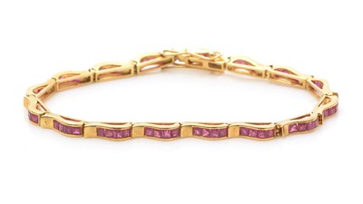 Lot 753 - A ruby and gold bracelet