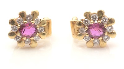 Lot 756 - A pair of ruby and diamond cluster earrings