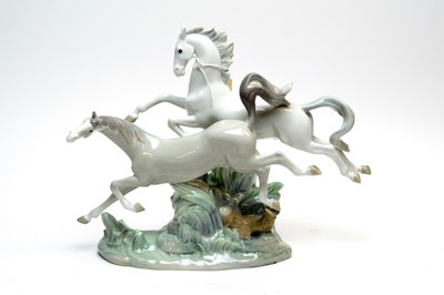 Lot 293 - A Lladro decorative ceramic figure group of Horses Galloping