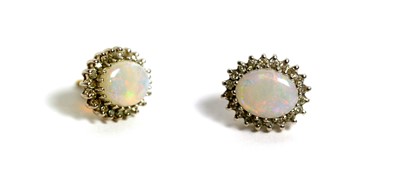 Lot 128 - A pair of opal and diamond cluster earrings