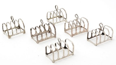 Lot 4 - A pair of George V small silver toast racks; and two further pairs
