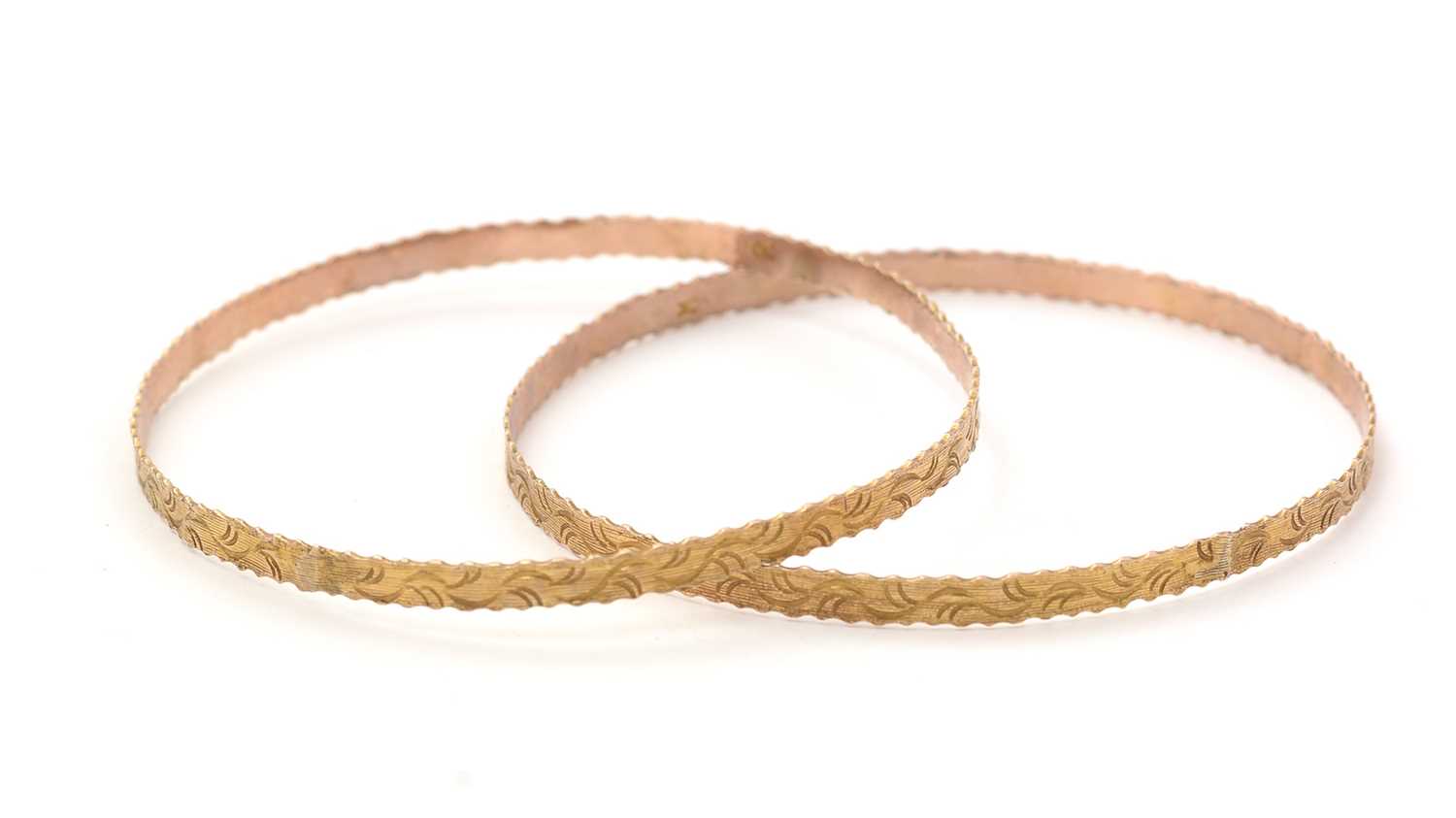Lot 157 - A pair of yellow gold bangles