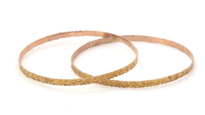 Lot 157 - A pair of yellow gold bangles